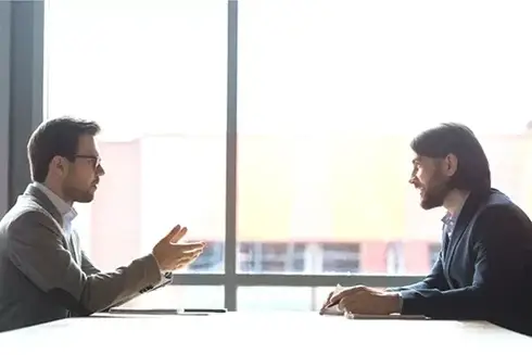 Coaching3-514x343 two business professionals sitting next to a window talking